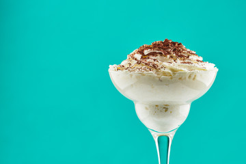 ice cream in glass with chocolate powder on Tiffani color background