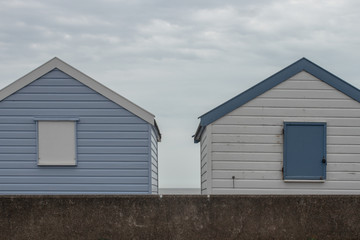 Fototapeta na wymiar Row beach huts, rental cabins and parking lot, iverted colors