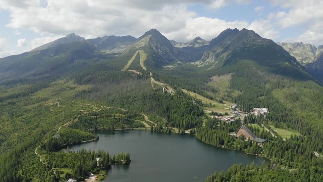 Forward Shot Flying over Alpine Lake on Foothill of Mountain Range, High Tatras