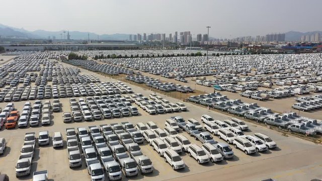 China automotive sector - drone flight of parking lot at car manufacturing plant in Qingdao