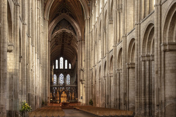 Tall gothic slyte cathedral interior nave with many arches and stained windows, ceremonial hall duomo Ely  