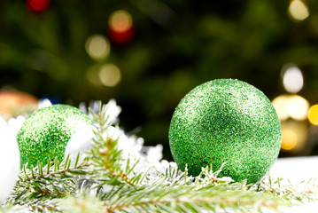 Modern Christmas composition. Christmas balls, green and silver decorations on white background....