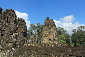 Fototapeta premium Ancient stone faces of Bayon temple in complex Angkor Wat in Siem Reap, Cambodia 