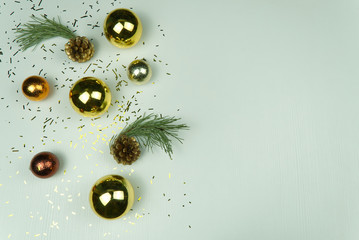 Modern Christmas composition. Christmas tree balls, brown and gold decorations with colored confetti on white background. Flat lay, top view, copy space. close up photo. can be used us postcard or