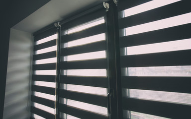 Sunlight enters the room through the blinds