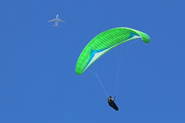 Paraglider flying wing in a blue sky	