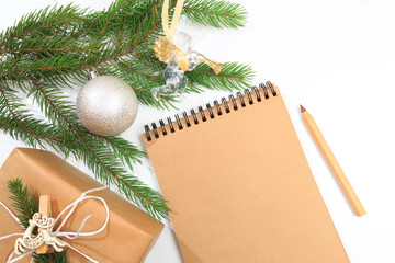 Top view of blank notebook on white background with xmas decorations. Mockup Christmas background with notebook for wish list or to do list. Flat lay with copy space. - Image