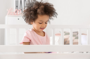 Little African-American girl sitting in bed