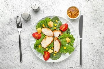 Plate with with tasty chicken salad on white background
