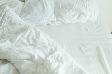 bed with white sheets close up bright light