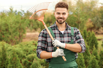 Portrait of handsome male gardener outdoors