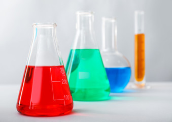 Flasks with colorful samples in laboratory