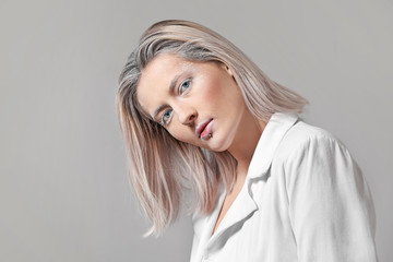 Fototapeta premium Beautiful woman with creative makeup on grey background