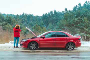 man standing near broken car at roadside snowed winter weather