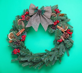 Fototapeta na wymiar Beautiful Christmas wreath on color background