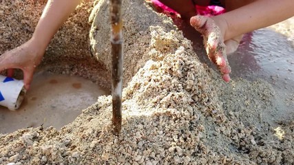 PASMAN, CROATIA, 2019.06.18: Closeup on kids and mother playing with the sand. Filming wonderful mediteranean countryside at sea vacation in Adriatic sea.