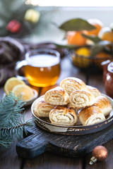 Oriental dessert gata with a cup of tea and tangerines on a wooden table. Selective focus