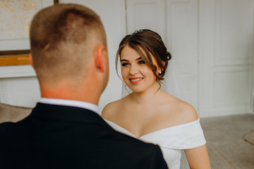 Dreamy bride and groom meeting in the room..Wedding day. Couple in love