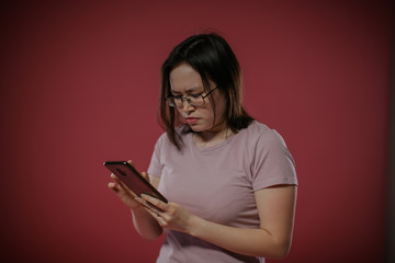Fototapeta premium Oriental girl holding a smartphone.
