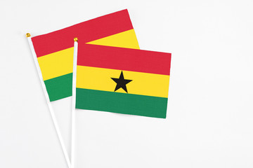 Ghana and Bolivia stick flags on white background. High quality fabric, miniature national flag. Peaceful global concept.White floor for copy space.