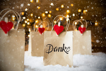 Christmas Shopping Bags On Snow With German Calligraphy Danke Means Thank You. Bright Glowing...