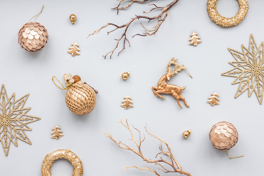 Gold christmas decoration on blue pastel background, top view, flat lay