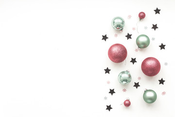 Christmas green, black, pink decorations on white background, top view, flat lay