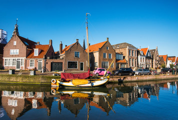 Fototapeta premium View of Monnickendam old town, Netherlands. Charming canal with boats in Waterland district near Amsterdam. Popular travel destination and tourist attraction
