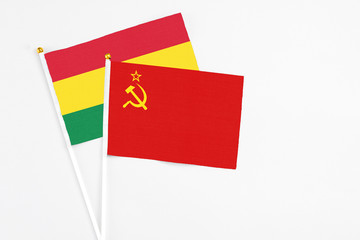 Soviet Union and Bolivia stick flags on white background. High quality fabric, miniature national flag. Peaceful global concept.White floor for copy space.