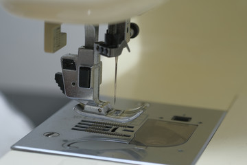 Closeup the sewing machine and needle with out sewing thread, selective focus. Royalty high-quality close up stock photo image of a needle with out sewing thread in sewing machine