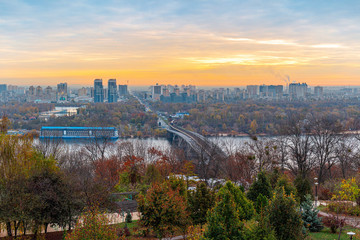Fototapeta na wymiar Panorama of Kyiv city and Dnipro river at sunrise in dawn, panoramic view to the colorful autumn cityscape in the morning, Ukraine