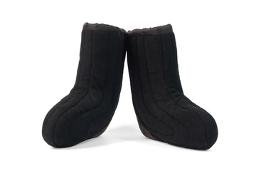 Russian traditional winter black boots-burki isolated on white background. Warm shoes for the elderly