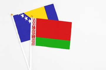 Belarus and Bosnia Herzegovina stick flags on white background. High quality fabric, miniature national flag. Peaceful global concept.White floor for copy space.