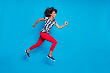 Fototapeta na wymiar Side profile full length body size photo of cheerful laughing cute nice pretty girlfriend jumping running towards shopping center isolated vivid blue color background