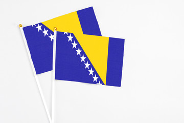 Bosnia Herzegovina and Bosnia Herzegovina stick flags on white background. High quality fabric, miniature national flag. Peaceful global concept.White floor for copy space.