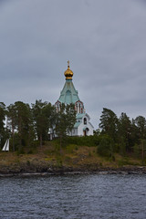 Orthodox chapel.A lonely Orthodox chapel in a forest on the shore of Lake Ladoga on the island of Valaam. The hipped roof and cross on the dome are visible. Russia, Karelia