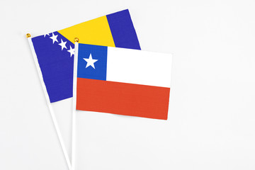 Chile and Bosnia Herzegovina stick flags on white background. High quality fabric, miniature...