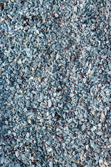 Small pebbles, granite marble stone chips, eco textured pedestrian paths. gray blue background backdrop texture