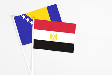 Egypt and Bosnia Herzegovina stick flags on white background. High quality fabric, miniature national flag. Peaceful global concept.White floor for copy space.