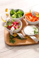 vegetable and dipping sauce- health food concept on wooden board
