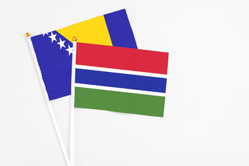 Gambia and Bosnia Herzegovina stick flags on white background. High quality fabric, miniature national flag. Peaceful global concept.White floor for copy space.