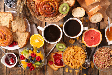 breakfast with cornflakes, coffee cup and fruits