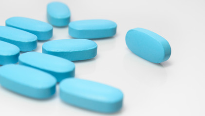blue pills on white background close-up