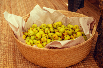 Basket with small green apples close up