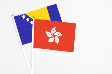 Hong Kong and Bosnia Herzegovina stick flags on white background. High quality fabric, miniature national flag. Peaceful global concept.White floor for copy space.