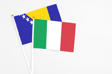 Italy and Bosnia Herzegovina stick flags on white background. High quality fabric, miniature...