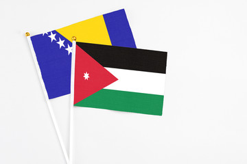 Jordan and Bosnia Herzegovina stick flags on white background. High quality fabric, miniature national flag. Peaceful global concept.White floor for copy space.