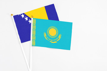 Kazakhstan and Bosnia Herzegovina stick flags on white background. High quality fabric, miniature...