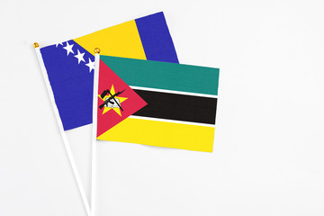 Mozambique and Bosnia Herzegovina stick flags on white background. High quality fabric, miniature...
