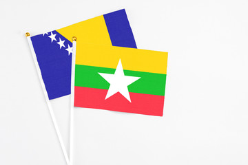 Myanmar and Bosnia Herzegovina stick flags on white background. High quality fabric, miniature national flag. Peaceful global concept.White floor for copy space.